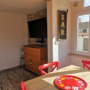 a dining room with a table and a television at Soulmate Rooftop Apartment in Rome