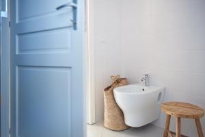 a bathroom with a white sink and a door at Seabay in Golfo Aranci