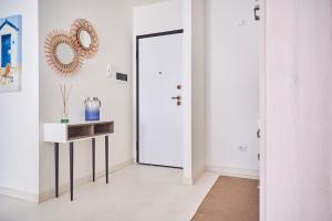 a hallway with a door and a table and a mirror at Seabay in Golfo Aranci