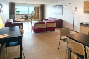 a living room with a couch and a table at Aparthotel Adagio Nice Promenade des Anglais in Nice