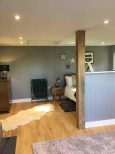 a bedroom with a bed with stars on the wall at Cute studio cottage. Wood burner. Amazing views in Longhope