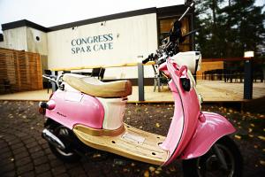 a pink scooter parked in front of a store at Hotel Kiljava in Kiljava