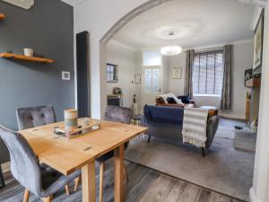 a living room with a table and a couch at 15 Clitheroe in Skipton