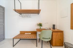 a desk and a chair in a room at Sarmenti Agriresort in Otranto