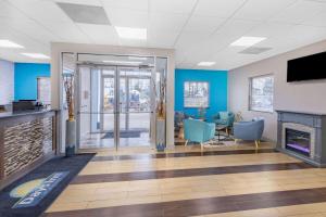 a lobby with a fireplace and blue walls at Days Inn by Wyndham Fredericksburg North in Fredericksburg