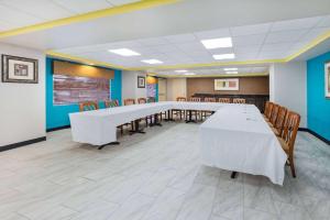 a conference room with a long table and chairs at Days Inn by Wyndham Fredericksburg North in Fredericksburg