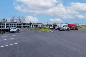a parking lot with trucks parked in front of a motel at Days Inn by Wyndham Fredericksburg North in Fredericksburg