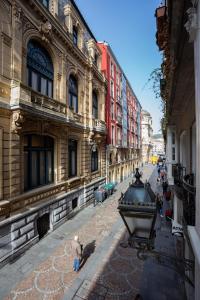 a city street with buildings and people standing on the street at Casual Arriaga in Bilbao