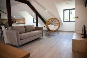 a living room with a couch and a chair at Les 3 sables, MACABI in L'Étang-Salé les Bains