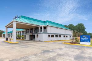 a building with a sign in front of it at Baymont by Wyndham Biloxi - Ocean Springs in Biloxi