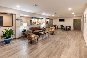 a living room with a couch and chairs at Baymont by Wyndham Biloxi - Ocean Springs in Biloxi