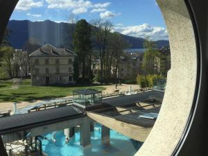 a view of a building with a pool of water at Studio Aix-les-Bains, 1 pièce, 2 personnes - FR-1-555-44 in Aix-les-Bains