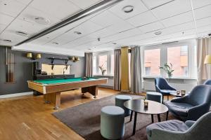 a billiard room with a pool table and chairs at Best Western Kom Hotel Stockholm in Stockholm