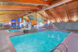 a large swimming pool in a hotel room at AmericInn by Wyndham Chippewa Falls in Chippewa Falls