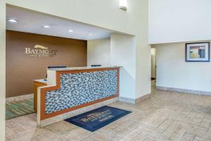 a lobby with a reception desk in a building at Baymont by Wyndham Beloit in Beloit