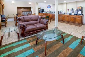 a lobby with a couch and two glass tables at Baymont by Wyndham Beloit in Beloit