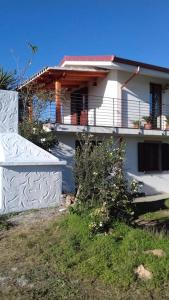 uma casa branca com uma varanda ao lado em Villetta relax em SantʼAnna Arresi