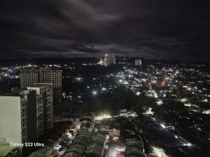a view of a city at night with lights at Casa de Rosand in Cebu City