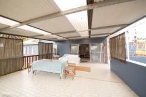 a screened in porch with a table and chairs at Bella@Jbay in Jeffreys Bay