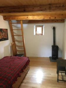 a bedroom with a bed and a wood stove at Rustico Ca'd'Damunt in Cevio