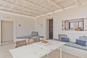 a living room with a white table and chairs at Blé - Traditional Renovated Cottage in Afiartis