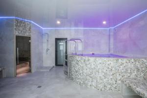 a bathroom with a tub with purple lighting at Salut in Bukovel +138 photos