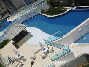 an overhead view of a swimming pool with chairs and tables at Porto Real Suites in Mangaratiba