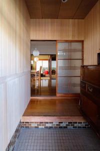 eine Küche und ein Esszimmer mit einer Glasschiebetür in der Unterkunft Vacation house月yue in Tokushima