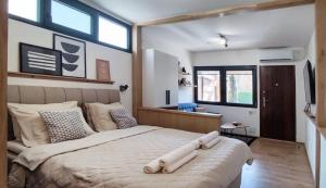a bedroom with a large bed with a large window at The House Apartments & Guest Rooms in Ohrid