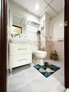 a bathroom with a sink and a toilet and a mirror at 66 Apartment in Ban Khlong Nong Yai