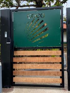 a green sign with the olympics on it at Villa des 3 sables, COCO in Étang-Salé les Bains