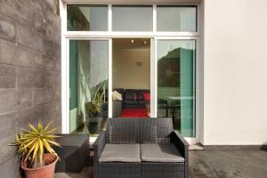 a patio with two chairs and a couch in front of a house at Madeira Villa Liliana in Campanário