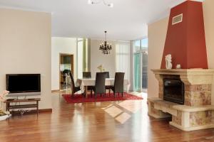 a dining room with a table and a fireplace at Madeira Villa Liliana in Campanário