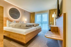 a hotel room with two beds and a flat screen tv at Hotel Beckmann in Göttingen