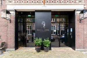 two plants in pots in front of a building at Vesting Hotel Naarden in Naarden