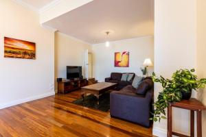 a living room with a couch and a table at Tanunda Central Apartment in Tanunda