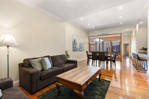 a living room with a couch and a table at Tanunda Central Apartment in Tanunda