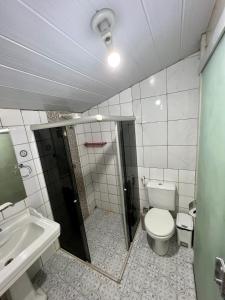 a bathroom with a toilet and a sink at Pousada das Flores in Fernando de Noronha