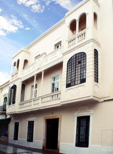 a white building with a balcony on top of it at Hotel Rural OLIVENZA PALACIO in Olivenza