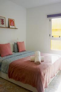 a bedroom with a bed with towels on it at Fuerteventura Beach Vacations in Puerto del Rosario