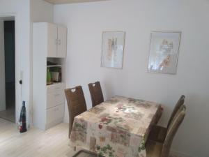 a kitchen with a table and two chairs and a table and a table at Ferienwohnung Talblick mit Schwimmbad in Bad Wildbad