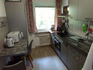 a small kitchen with a counter and a window at Ferienwohnung Talblick mit Schwimmbad in Bad Wildbad