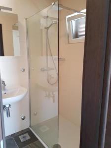 a shower with a glass door next to a sink at Holiday home in Milna with terrace, air conditioning, WiFi, washing machine 5123-1 in Milna