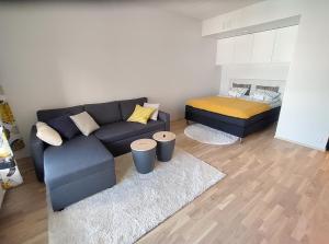 een woonkamer met een bank en een bed bij Fully Equipped New Apartment With Free Parking in Tampere
