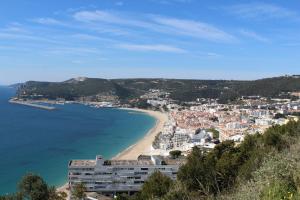 a view of a beach and a city at Casa da Tia in Sesimbra