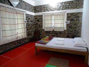 En eller flere senge i et værelse på Sabala Heritage Home