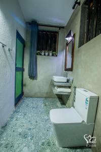 a bathroom with a toilet and two sinks in it at Yaal by Aryaana - Villa in Yala in Tissamaharama