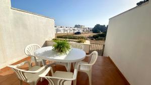 a white table and chairs on a balcony at Duplex Ancla in L'Ametlla de Mar