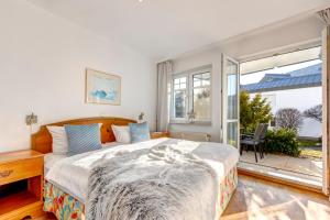 a bedroom with a bed and a large window at Seepark 705 in Bansin