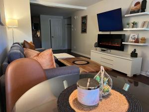 a living room with a couch and a table at L'escale d'Orford in Orford